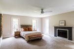 Master bedroom with tons of space and decorative fireplace